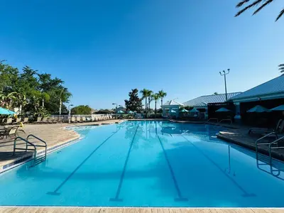 a large swimming pool with blue water at 4 bed Single Level Home in Windsor Palms Sleeps 8 in Kissimmee