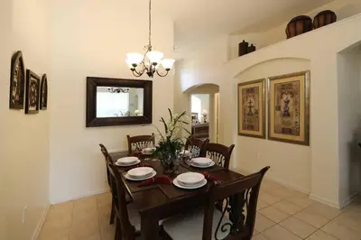 a dining room with a table and chairs at 4 bed Single Level Home in Windsor Palms Sleeps 8 in Kissimmee