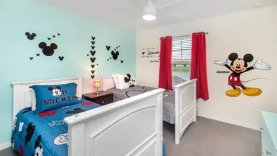 a room with a mickey mouse bedroom with a bed at City Palm Villa in Orlando