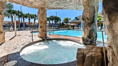 a swimming pool with a hot tub in a resort at City Palm Villa in Orlando