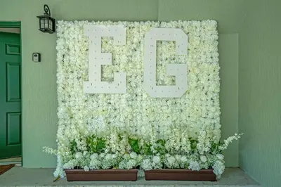 a wall covered in white flowers with the letter e at Sunny Summer Stay - Renovated TownHome by Disney! in Orlando
