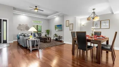 a living room with a table and a dining room at Family Summer Trip - Renovated TownHome by Disney! in Orlando