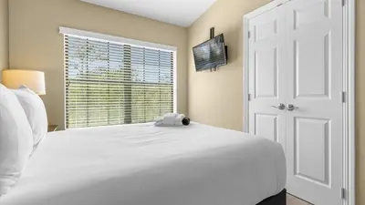 a bedroom with a white bed and a window at Family Summer Trip - Renovated TownHome by Disney! in Orlando