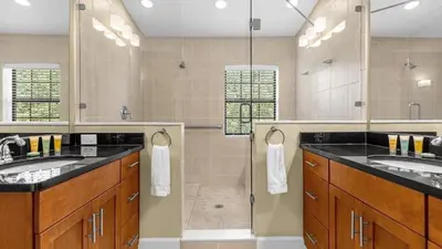 a large bathroom with two sinks and a shower at Family Summer Trip - Renovated TownHome by Disney! in Orlando