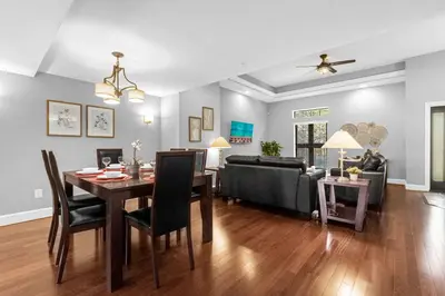 a dining room and living room with a table and a couch at Sunny Summer in FL - Relax in a TownHome by Disney! in Orlando