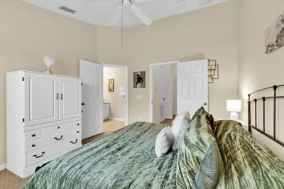a bedroom with a bed and white cabinets at The Sunny Nest in Orlando