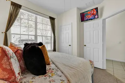 a bedroom with a bed and a window at The Sunny Nest in Orlando