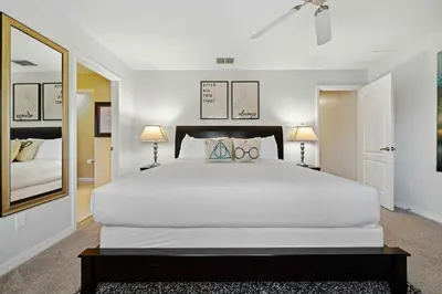 a bedroom with a large white bed and two lamps at 8953 Candy Palm Road in Kissimmee