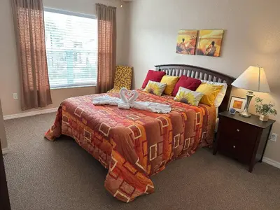 a bedroom with a bed with a blanket on it at Casa 4 Quartos - 20min Disney - Seven Dwarfs in Kissimmee