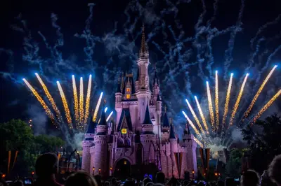 a nighttime picture of cinderella castle with fireworks at Holiday Inn Express & Suites Clermont SE - West Orlando by IHG in Orlando