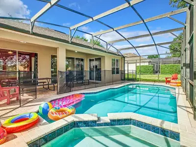 a swimming pool with inflatables in a house at Single Level 2 KING BEDS - 4BedrmPOOL-SPA-Disney in Orlando