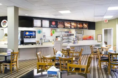 a dining room with tables and chairs in a restaurant at 6165 Carrier Drive Unit 1802 Building 1 in Orlando