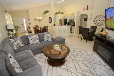 a living room with a couch and a table at Gorgeous 4 Bed Home In Gated Community in Kissimmee