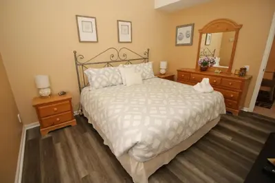 a bedroom with a bed and two dressers and a mirror at Luxury Villa Private Pool And Great Game Room in Kissimmee