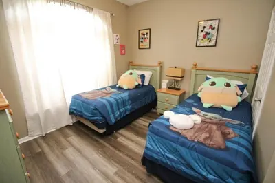 a bedroom with two beds with stuffed animals on them at Luxury Villa Private Pool And Great Game Room in Kissimmee