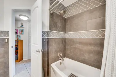 a bathroom with a white tub and a shower at 10 Mi to Disney World Lakeside Orlando Getaway! in Orlando