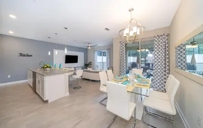 a dining room and living room with a table and chairs at 5011CL TOWNHOME 4 BEDS 3 BATHS FREE WATERPARK in Kissimmee