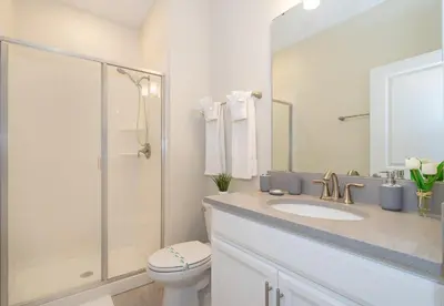 a bathroom with a toilet and a sink and a shower at 5011CL TOWNHOME 4 BEDS 3 BATHS FREE WATERPARK in Kissimmee