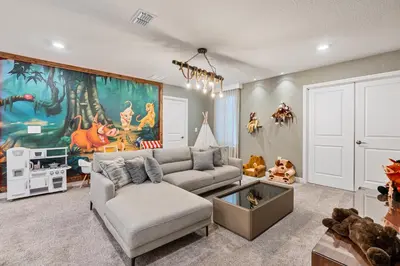 a living room with a couch and a large painting at New Home 9 Bedrooms and 5 Bathrooms At Storey Lake in Kissimmee
