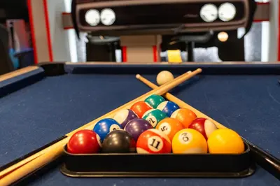 a tray of billiard balls on a pool table at New Home 9 Bedrooms and 5 Bathrooms At Storey Lake in Kissimmee