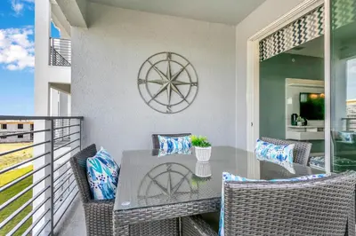 a patio with a table and chairs on a balcony at 3120 Paradox Circle 301 in Kissimmee