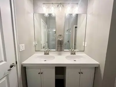a bathroom with two sinks and a large mirror at Sweet Stay with fully fenced yard in Sanford