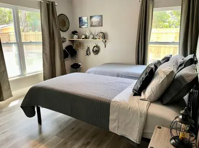 a bedroom with two beds and a window at Sanford's Seahaven in Sanford