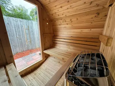 an inside view of a wooden sauna with a window at The Butterfly House - with sauna in Sanford