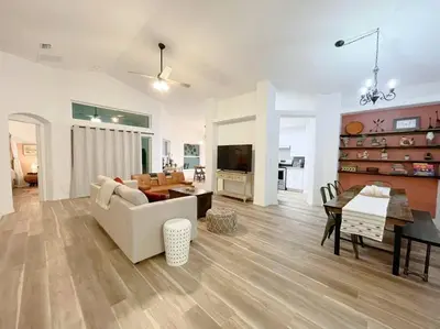 a living room with a couch and a table at The Sanford Ave House with fully fenced yard in Sanford