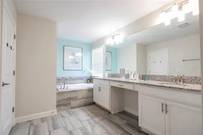 a bathroom with two sinks and a bath tub at Amazing home at Storey lake 2 minutes to clubhouse in Kissimmee