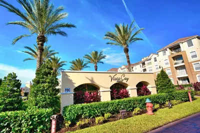 a building with palm trees and a fire hydrant at The Epic Colorado Vista Cay Orlando in Orlando