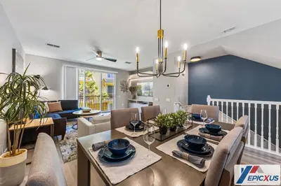 a dining room and living room with a table and chairs at The Epic Colorado Vista Cay Orlando in Orlando