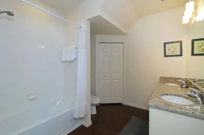 a bathroom with a tub and a sink and a toilet at Your VIP Home in Orlando Disney 25106 in Kissimmee