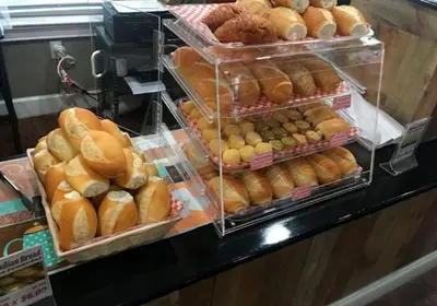 a display case filled with lots of different types of bread at Your VIP Home in Orlando Disney 25106 in Kissimmee