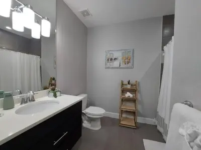 a white bathroom with a sink and a toilet at Serenity Close to Disney Orlando in Orlando