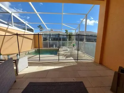 a balcony with a view of a swimming pool at Serenity Close to Disney Orlando in Orlando