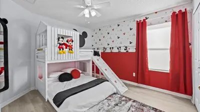a childs bedroom with a white bunk bed and red curtains at Ever After Adventure Villa - Themed Rooms, Game Room, Private Pool Near Disney in Kissimmee