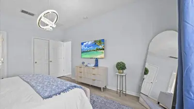 a white bedroom with a bed and a mirror at Ever After Adventure Villa - Themed Rooms, Game Room, Private Pool Near Disney in Kissimmee