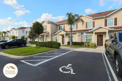 a car parked in a parking lot in front of houses at NEW Renewed 3BD Modern 10 Min to Disney in Kissimmee