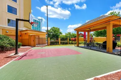 a basketball court with a gazebo and a basketball hoop at Pool view apartment near Epic Universe and Universal Studios in Orlando