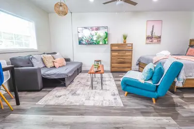 a living room with a bed and a couch and a table at NEW Designed Apt 2023 NrUCF PETSOk PrivateEntry in Orlando