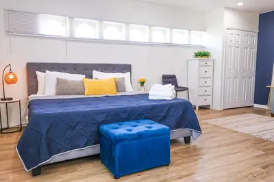a bedroom with a large bed with a blue comforter at NEW5 LUXURYSTUDIO Nr DISNEY PETSOKprivENTRY in Kissimmee
