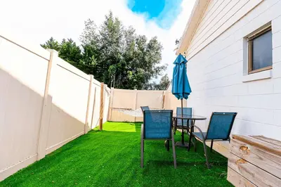 a patio with a table and chairs and an umbrella at NEW5 APT NrUCF PETSOK PRIVATE patioENTRY LAUNDRY in Orlando
