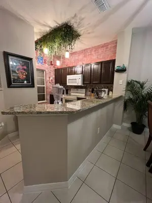 a kitchen with a large counter in a room at Magical Themed Home, Potter, Peter Pan 3mi Disney in Kissimmee