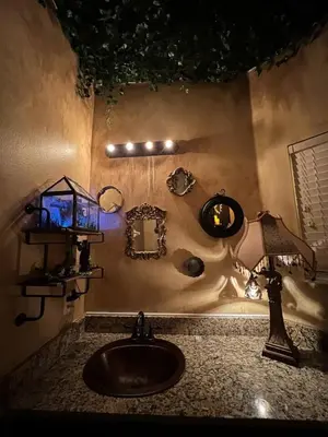 a bathroom with a sink and a mirror and lights at Magical Themed Home, Potter, Peter Pan 3mi Disney in Kissimmee