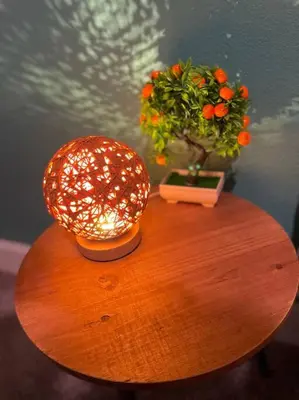 a table with a lamp and a plant on it at The Sanford Bandstand in Sanford