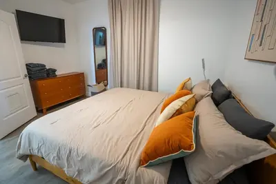 a bedroom with a bed with pillows on it at Orlando 4th Floor - 5 min Disney in Orlando