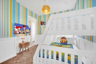 a childs bedroom with a white bunk bed at Enchanted Home Near Disney in Orlando
