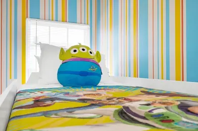 a bed with a cartoon frog on top of it at Enchanted Home Near Disney in Orlando