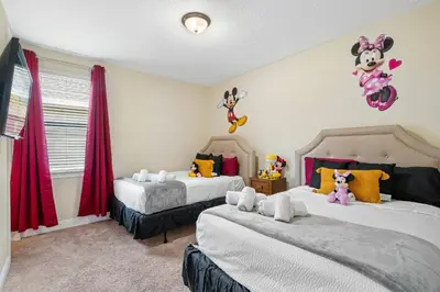 a bedroom with two beds with stuffed animals on the wall at Encore Resort 5 Bedroom Home with Pool 2403 in Orlando